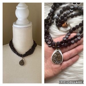 Artisan made boho eggplant colored wooden beads with a abalone shell pendent